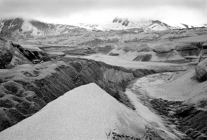 An ash-covered snowfield within the Lower Knife Creek Glacier, 2002. (© Gary Freeburg)